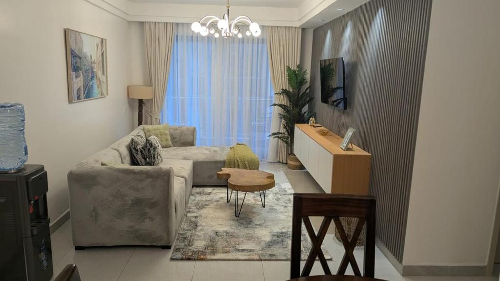 a living room with a couch and a table at Oceania Suites 5 Minutes from Jomo Kenyatta international Airport in Nairobi