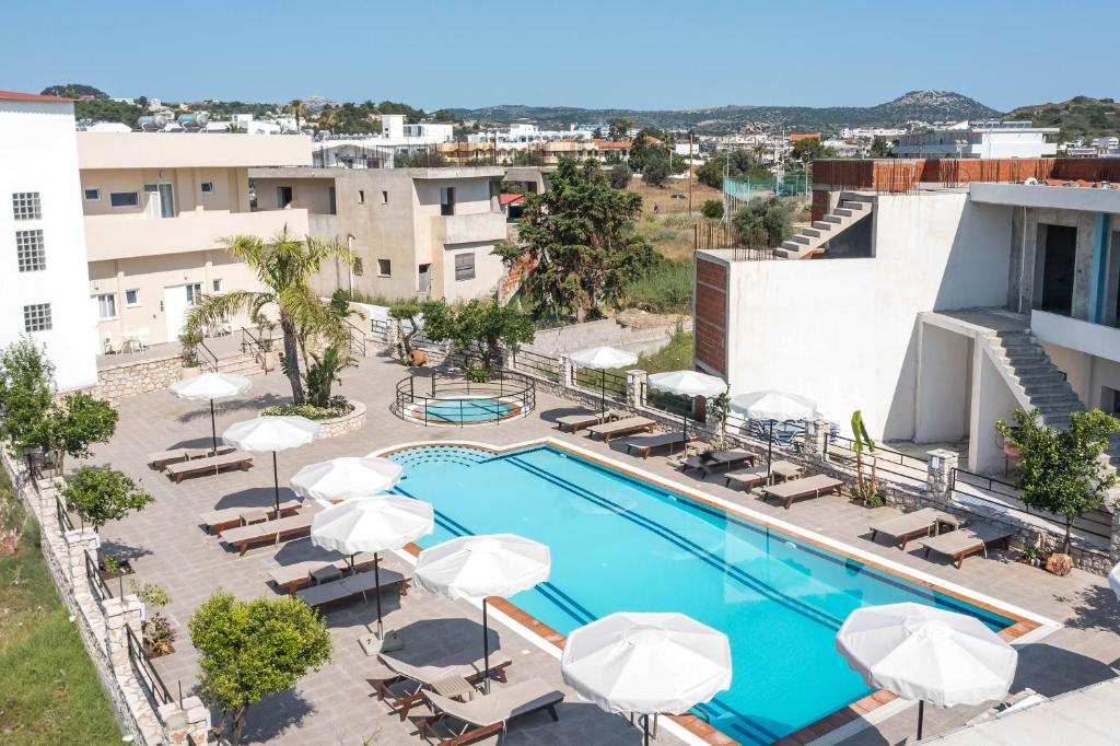 an image of a pool at a hotel with umbrellas at Olevia Comfort in Faliraki