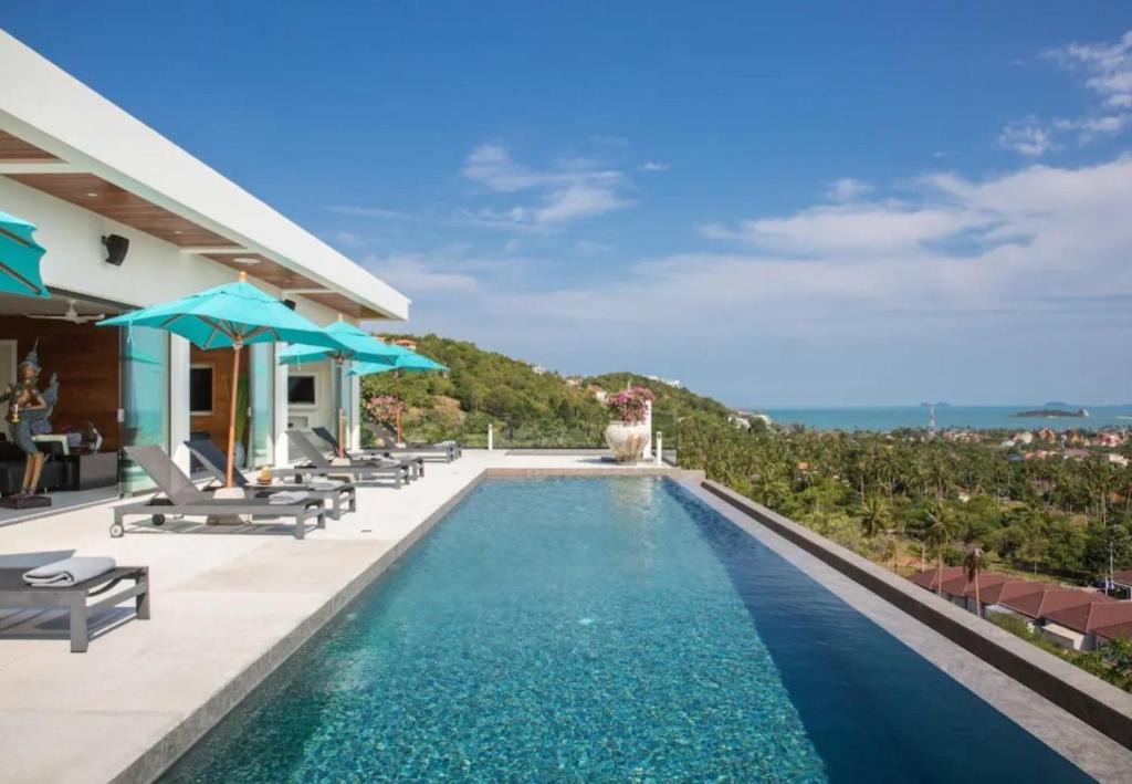 a villa with a swimming pool with a view at Villa Danisa 4BR Panoramic Ocean View with Infinity Pool & Private Gym in Choeng Mon Beach