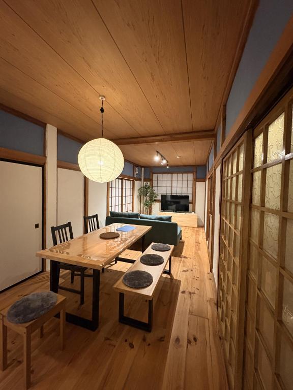 a dining room with a table and a couch at 城北ノイエ by mooi in Aizuwakamatsu