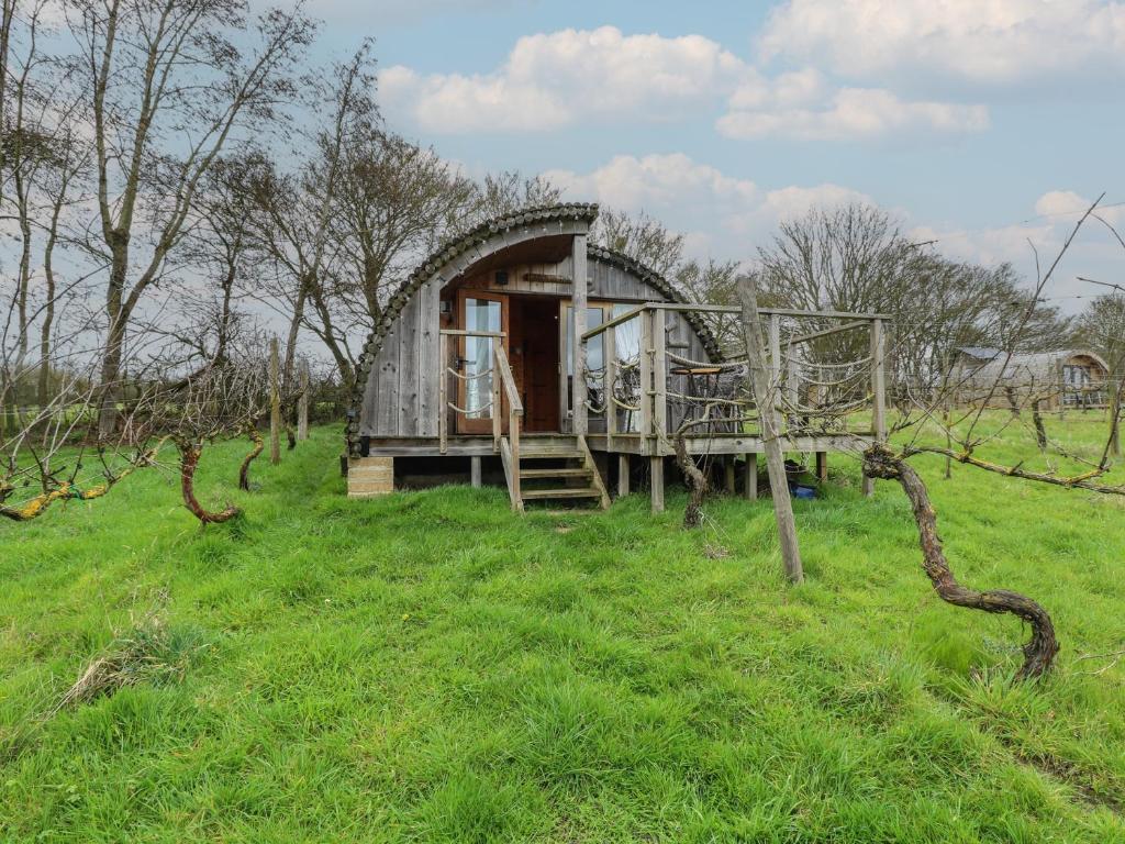 a tree house in the middle of a field at Grape Escape in Halesworth