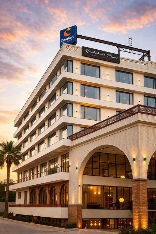 a building with a sign on top of it at Comfort Hotel Kishore Azamgarh in Āzamgarh