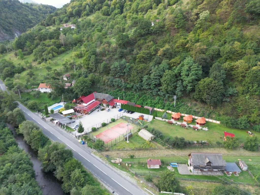 an aerial view of a house on a hill next to a road at Podul Cetatii in Sebeşel