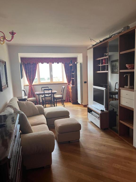 a living room with a couch and a tv and a table at Luca Residence in Timişoara