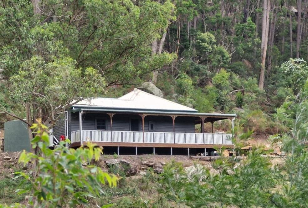 a large house with a porch on a hill at Himmel Haus in Laguna