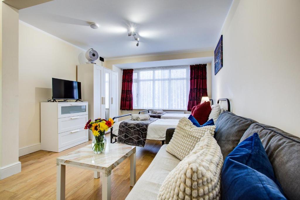 a living room with a couch and a table at Smart Studio- North London - Sleeps 2 - free parking in London