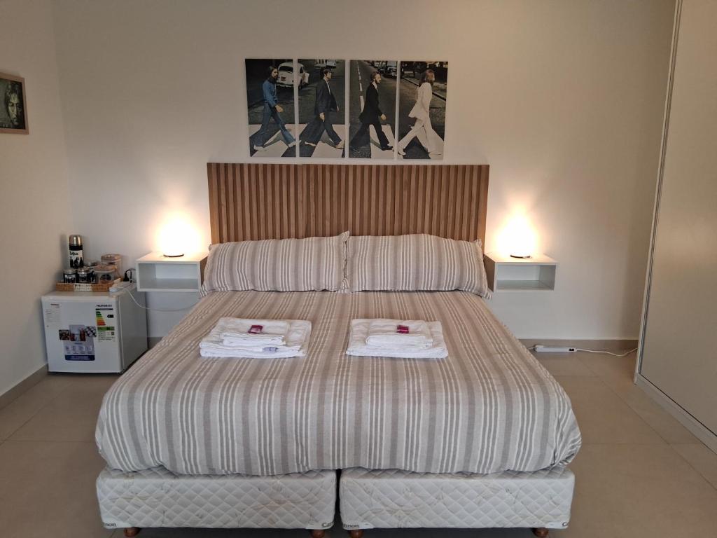 a bedroom with a bed with two towels on it at Lenn Rem Eze in Ezeiza