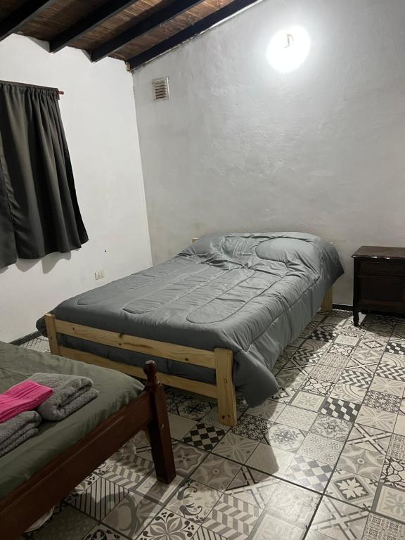 a bedroom with two beds in a room at Departamento Favaloro in RSA