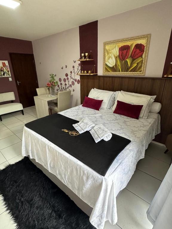 a bedroom with a large bed with a robe on it at Flat JK 103 in Juazeiro do Norte