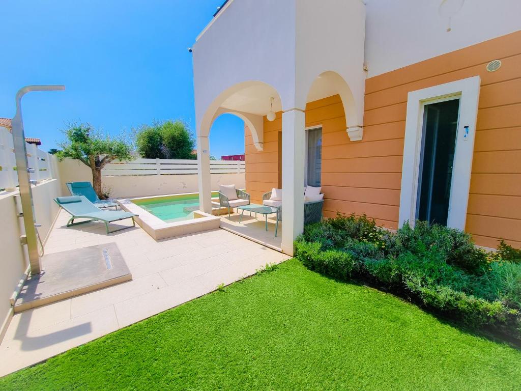 a house with a patio and a swimming pool at Calypso Luxury Pool&Spa in Pula
