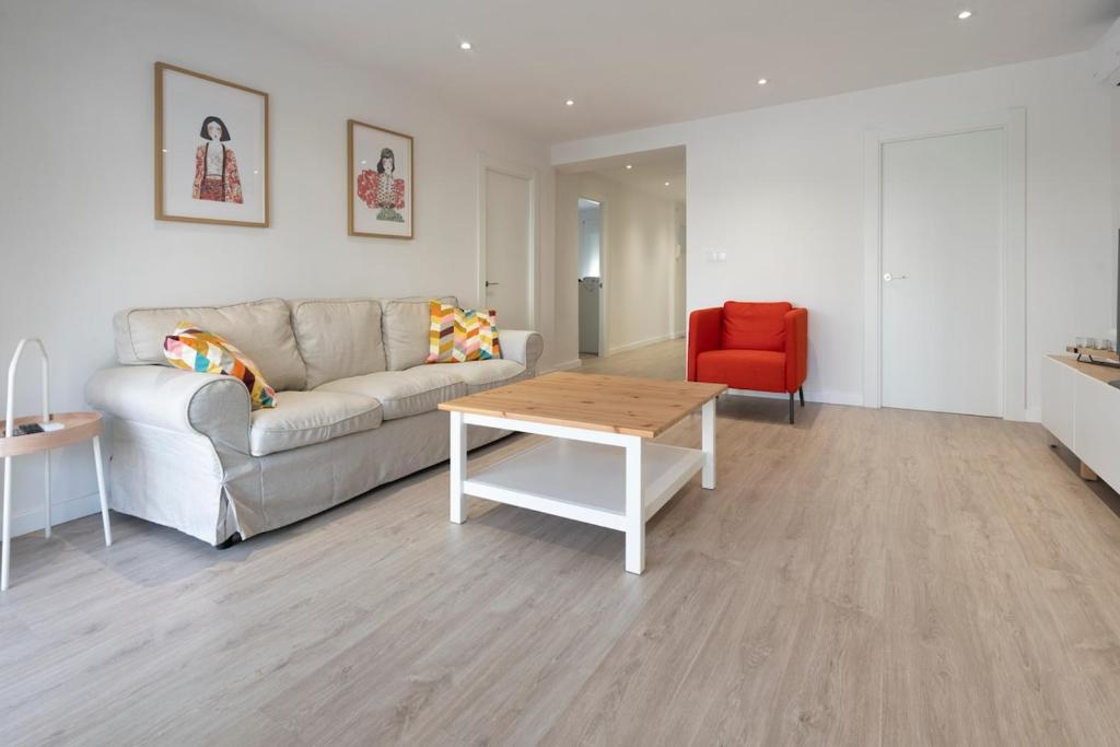 a living room with a couch and a table at Playa Anaconda - Wellhome Alicante in Benimagrell