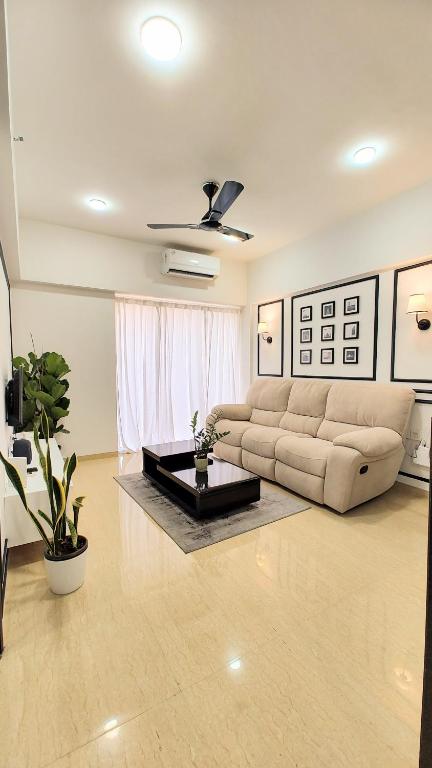 a living room with a couch and a coffee table at Monochrome County 16th floor in Dehu Road