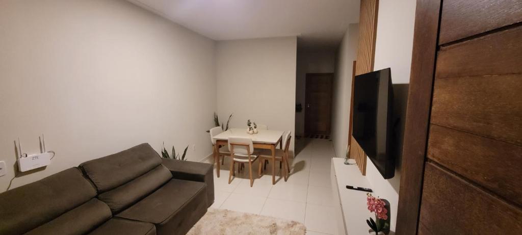 a living room with a couch and a table at Casa aconchegante e estruturada in Bragança