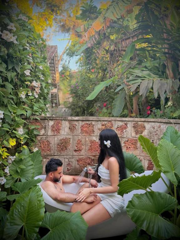 a man and a woman sitting in a bath tub at Foozoo Mantra Weligama in Weligama