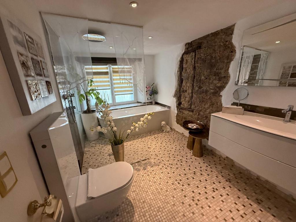 a bathroom with a toilet and a tub and a sink at Luxus Domizil in Villingen-Schwenningen