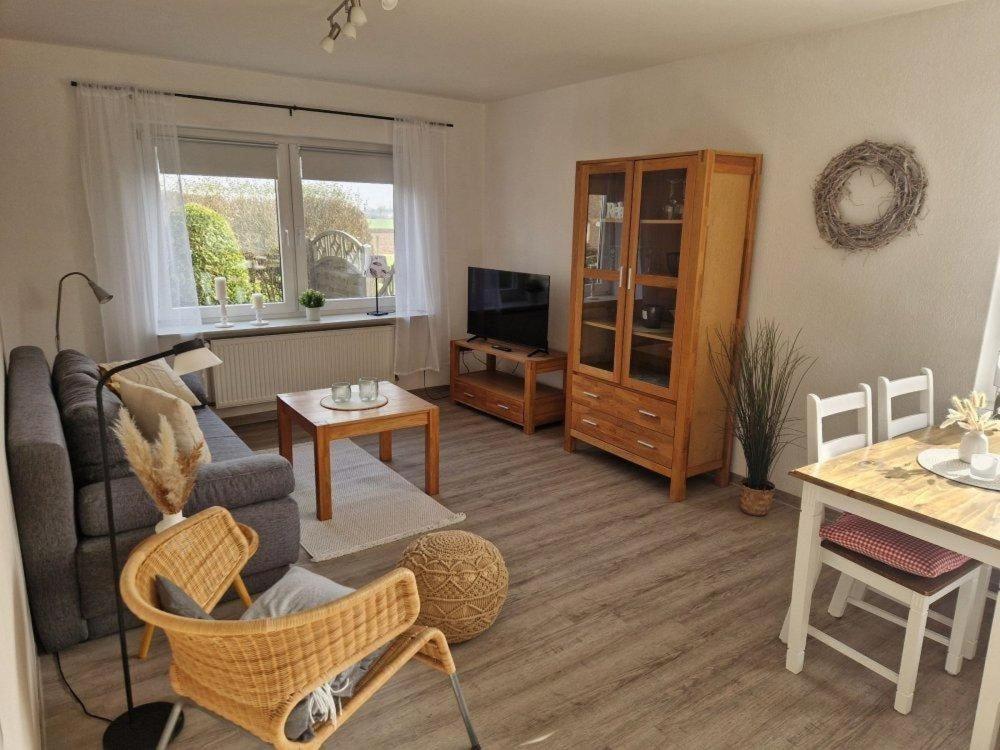 a living room with a couch and a table at Rotbuche in Ruhwinkel