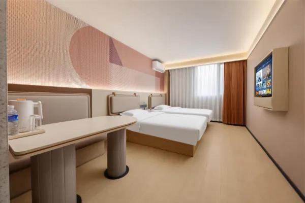 a hotel room with a bed and a desk and a tv at Zhuoya Garden Hotel in Beijing