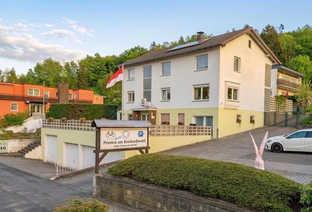 a building with a sign in front of it at Pension Genz in Bad Karlshafen