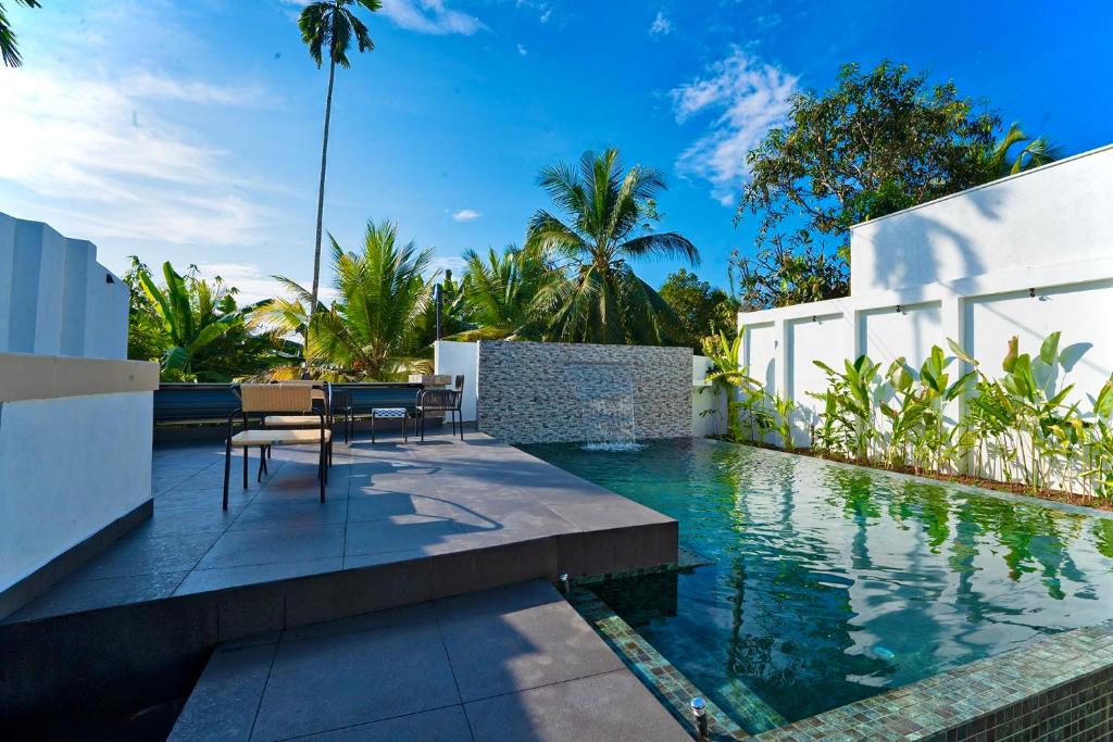 a swimming pool in the backyard of a villa at Villa Sanchana in Galle