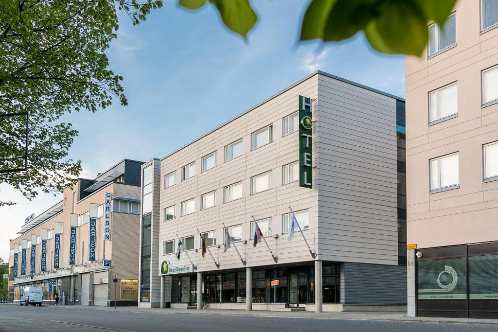 a building on a street with buildings at GreenStar Hotel Joensuu in Joensuu