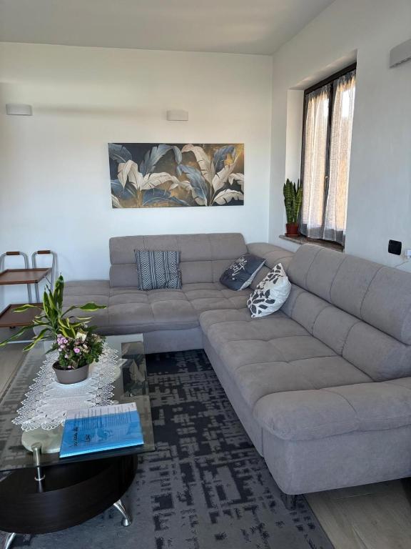 a living room with a couch and a table at La casa di Gio' Lake Maggiore Near Leonardo in Dormelletto