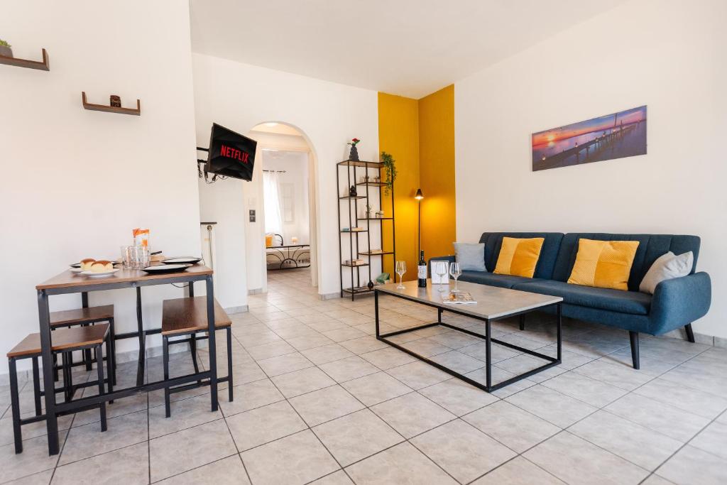 a living room with a couch and a table at Ionian Luxury Apartments in Perama