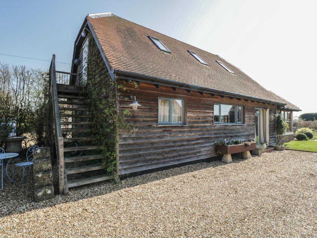 a log cabin with a staircase in front of it at The Hideaway Loft in Chippenham