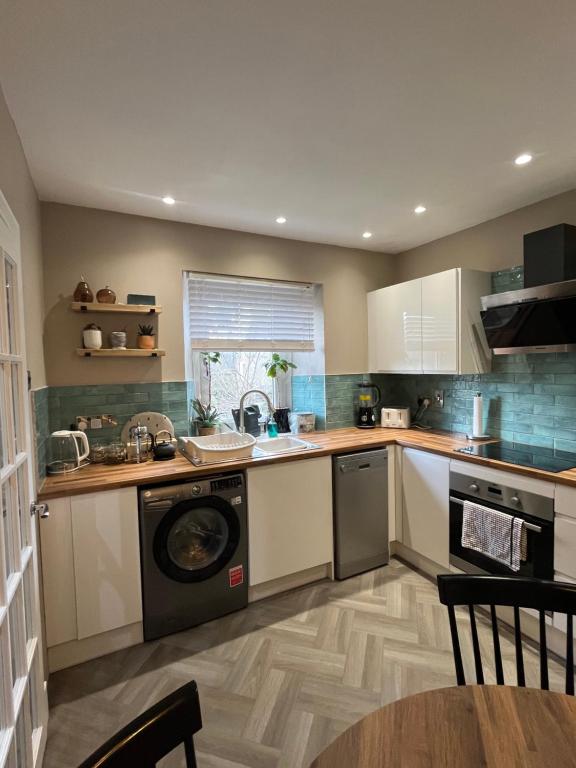 a kitchen with a washer and a dishwasher at The Ferry Loft Montrose in Montrose