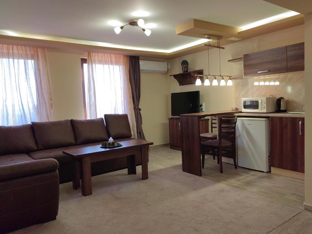 a living room with a couch and a kitchen at Пиргуля in General-Toshevo