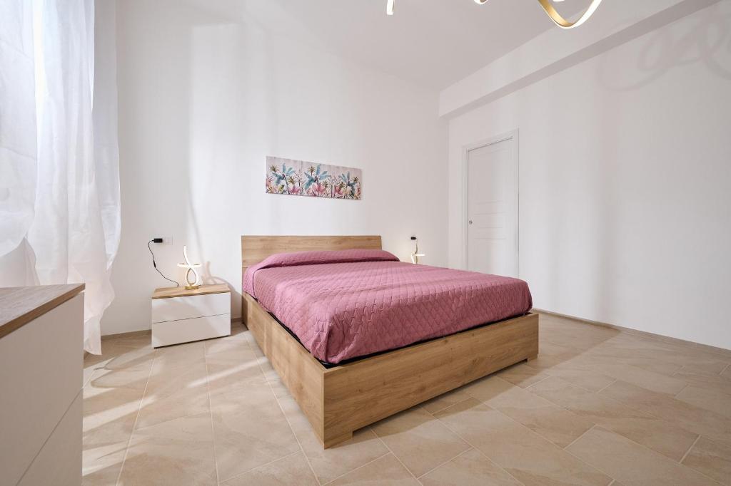 a bedroom with a bed in a white room at Casa La Viola - Follonica in Follonica