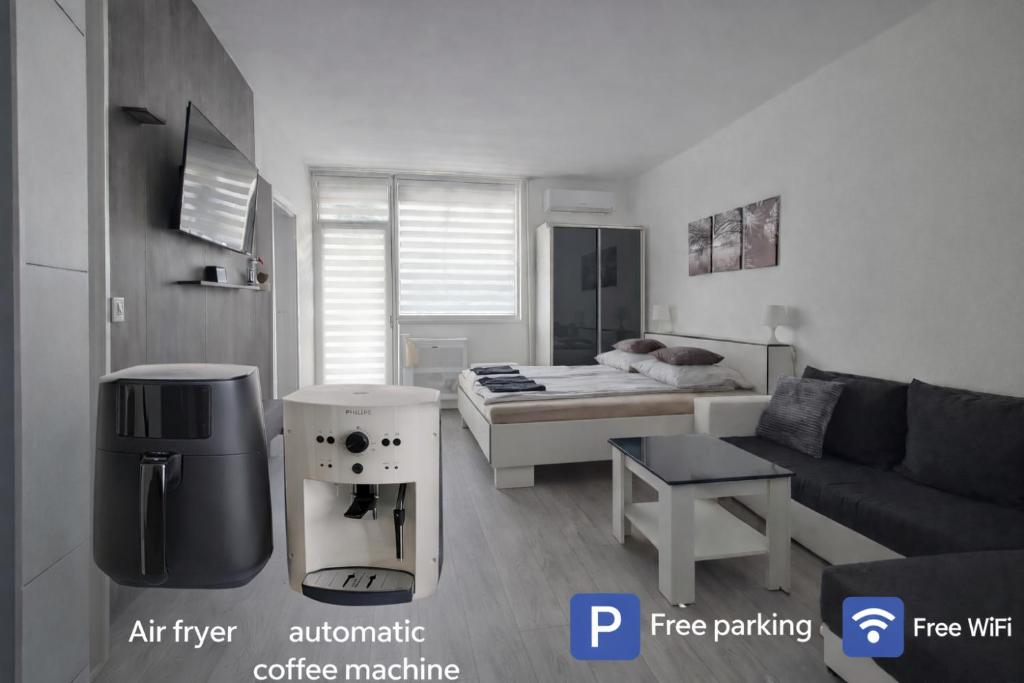 a small living room with a couch and a bed at Grey Harmony Apartman in Debrecen
