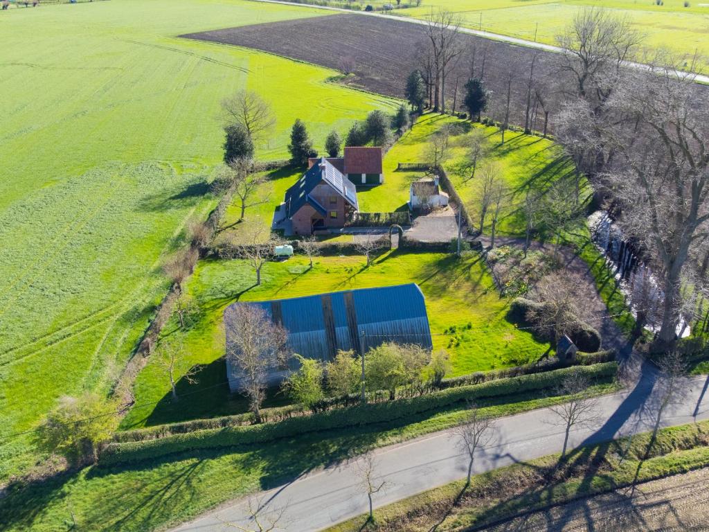 an aerial view of a farm with a house and a road at t' Zwaluwnestje in Zedelgem