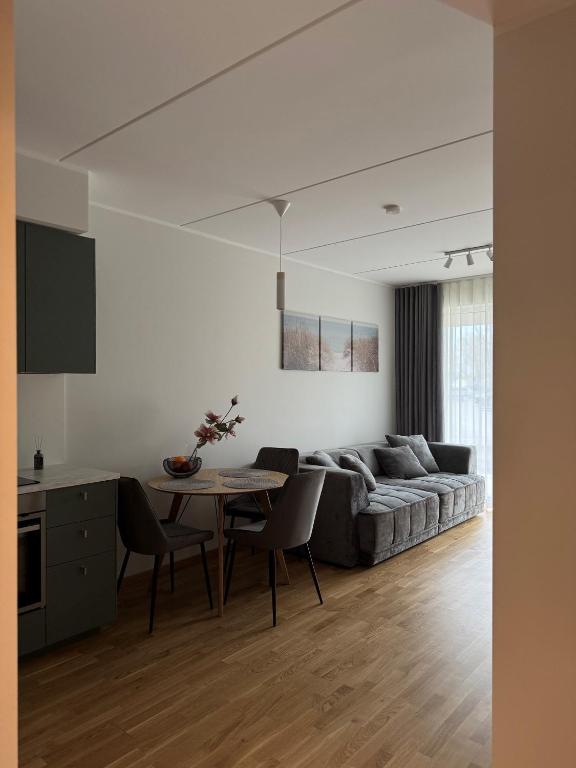 a living room with a couch and a table at Loo Apartment in Loo