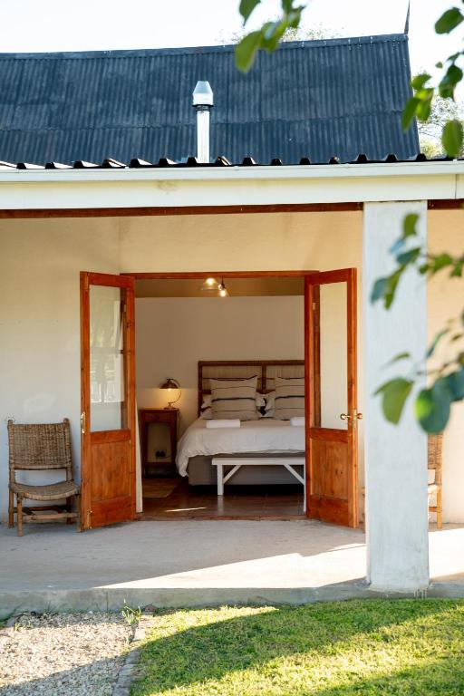 a bedroom with a bed inside of a house at Karoo House Collection - Riverdene Lodge in Nieu-Bethesda