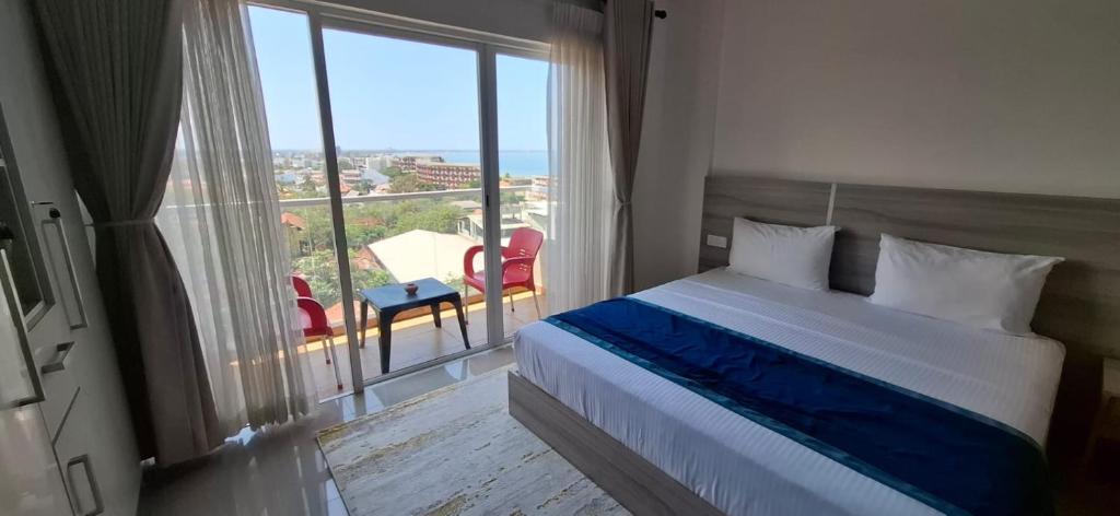 a bedroom with a bed and a large window at Luxury Sea View Apartments in Negombo