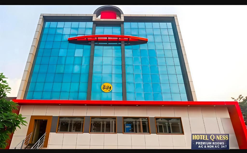 a building with a sign on the side of it at Hotel Qness in Hyderabad