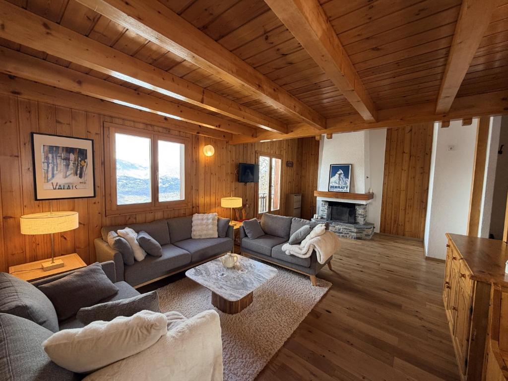 a living room with a couch and a table at Fontannets 001 COSY & MOUNTAIN chalet 10 pers in Veysonnaz