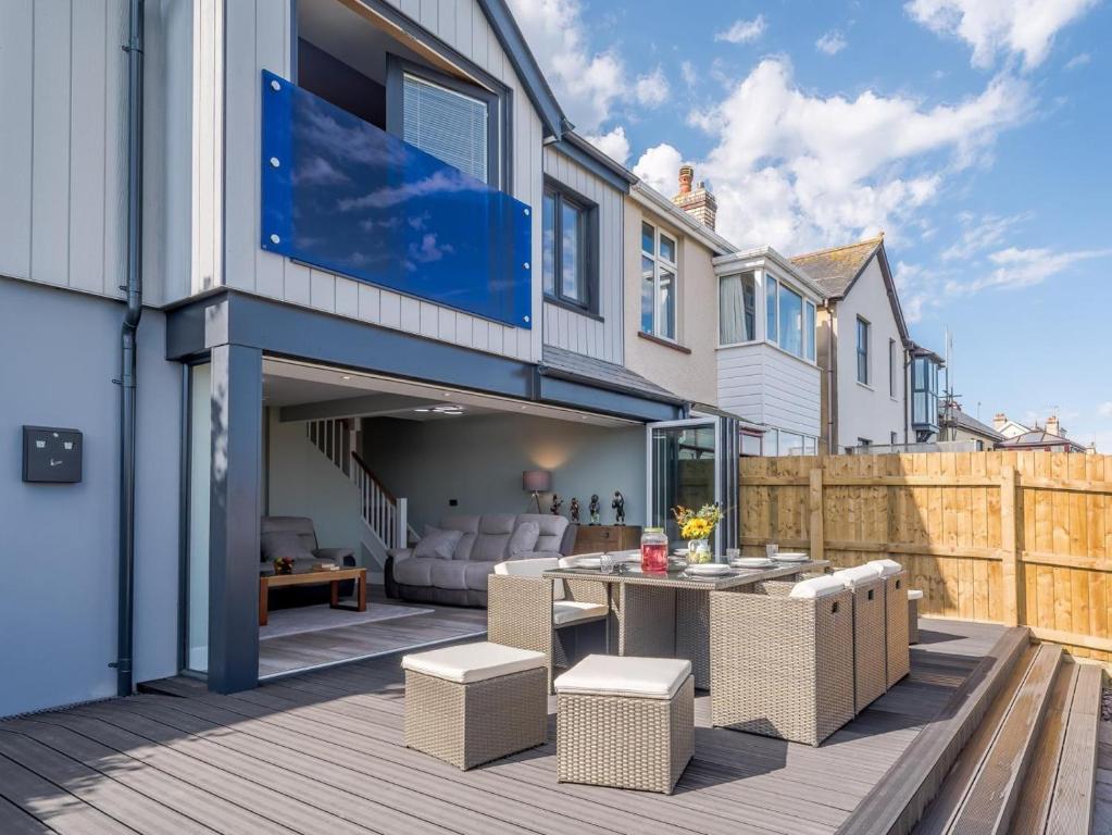a patio with a table and chairs on a deck at 3 Bed in Bideford oc-78796 in Northam