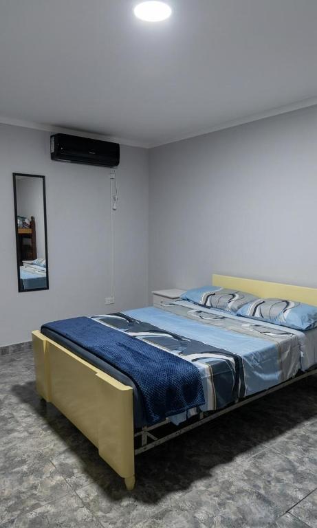 a bedroom with a large bed with blue sheets at Norte Hogar in Salta