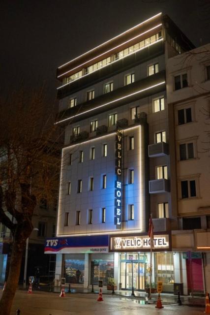 a large building with a sign in front of it at Kucuk Velic Hotel in Gaziantep