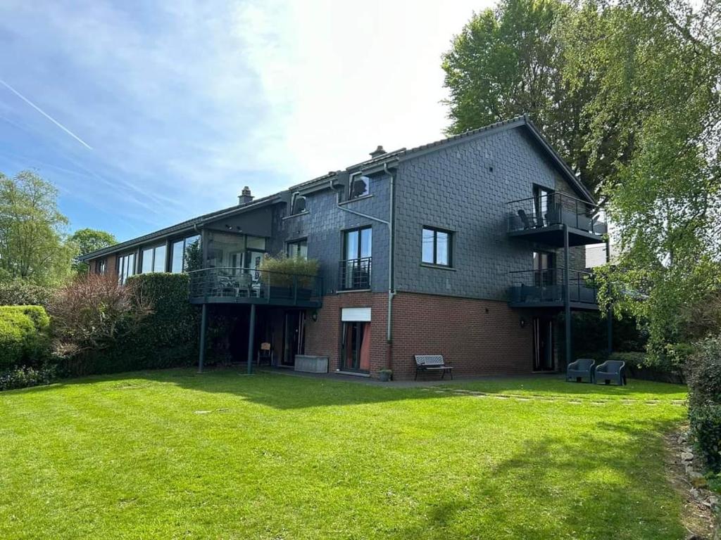 a large house with a lawn in front of it at L'Horizon Studios & Apparts in Malmedy