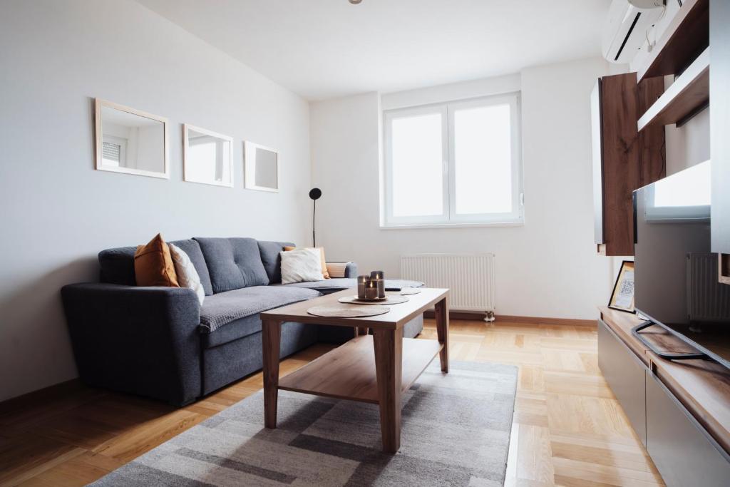 a living room with a couch and a coffee table at Sky View - Apartment & GARAGE, Banja Luka in Banja Luka