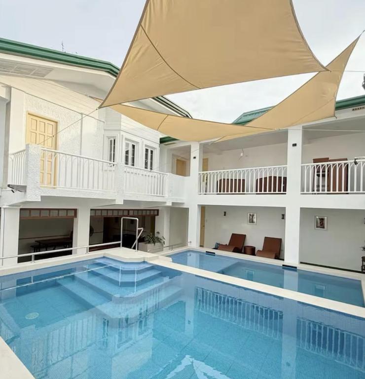 a large swimming pool with a large ceiling at Casa Sakura 2 in Calamba