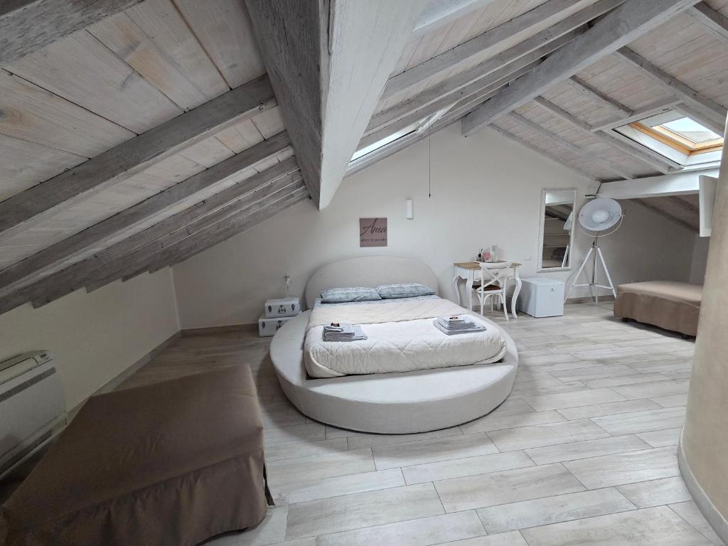 a bedroom with a large bed in the middle of the room at AMA AFFITTACAMERE in Albenga