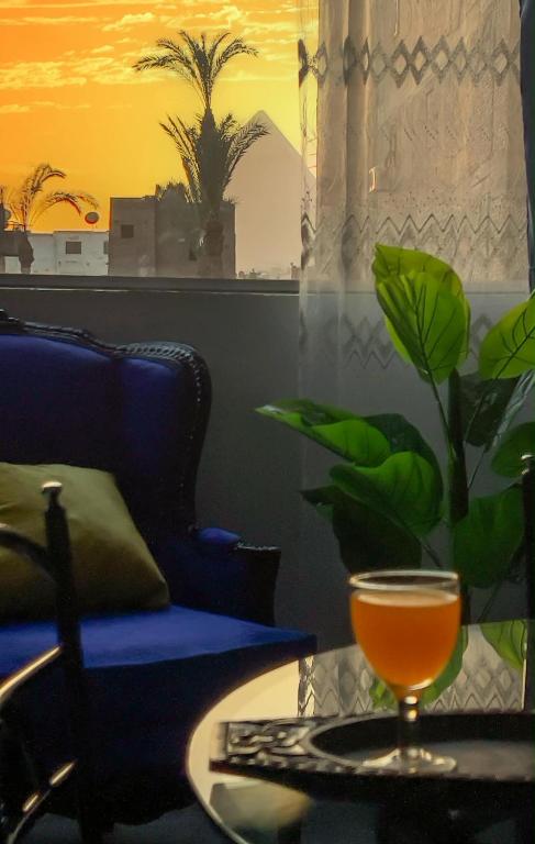 a glass on a table with a glassasteryasteryasteryasteryasteryasteryasteryastery at Casa Pyramids View in Cairo