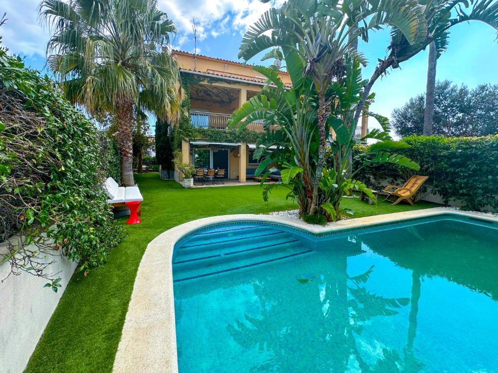 a swimming pool in the yard of a house at Villa Rocamar by Hello Homes Sitges in Sitges