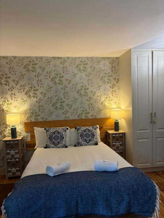 a bedroom with a large bed with two pillows at Professional & Approved Self Catering Short Term Holiday Homes in Maynooth