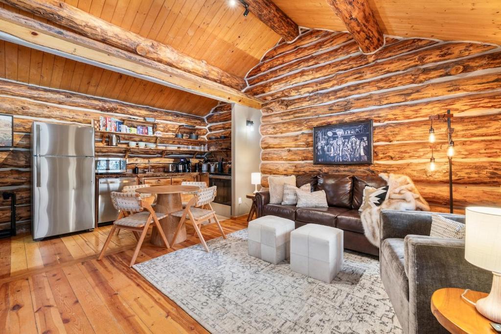 a log cabin living room with a couch and a table at Pinecrest Cabin- Serene Black Hills Getaway in Rapid City