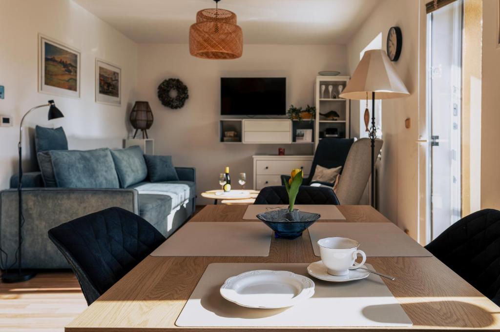 a living room with a table and a couch at Cyklo Apartmán Třeboň in Třeboň