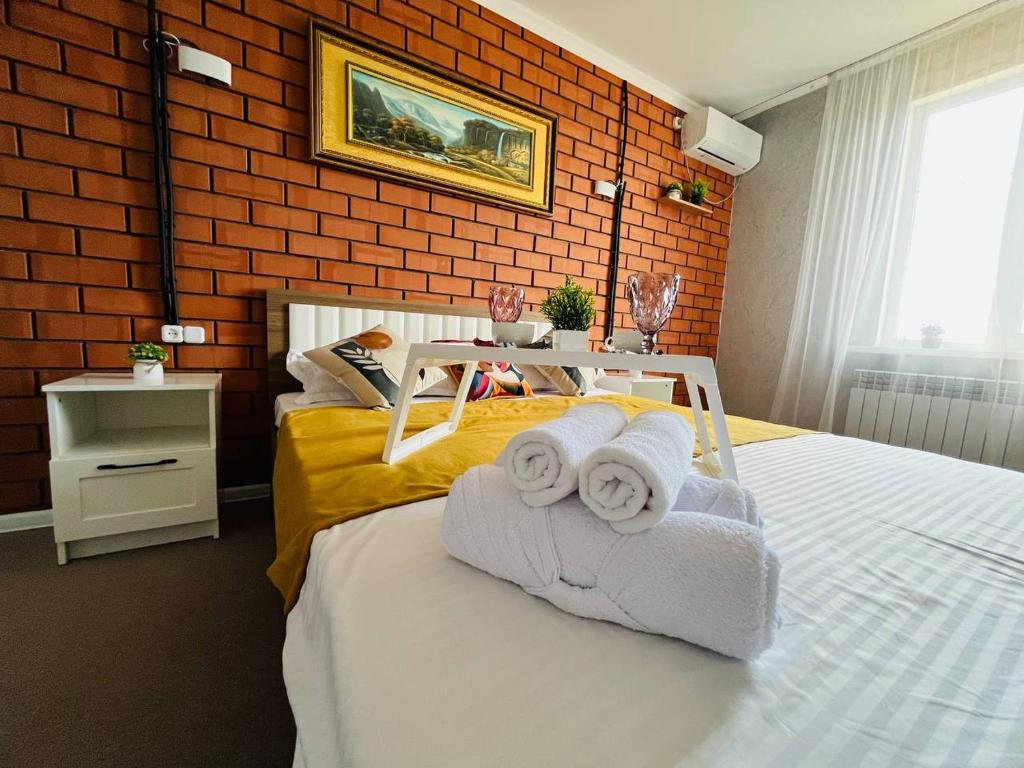 a bedroom with two beds with towels on them at Halqyma Hotel in Oral